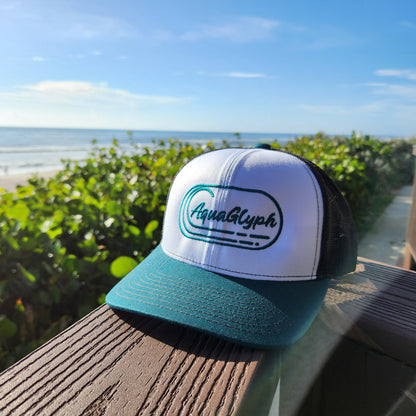 AquaGlyph Peacock Logo Trucker Hat